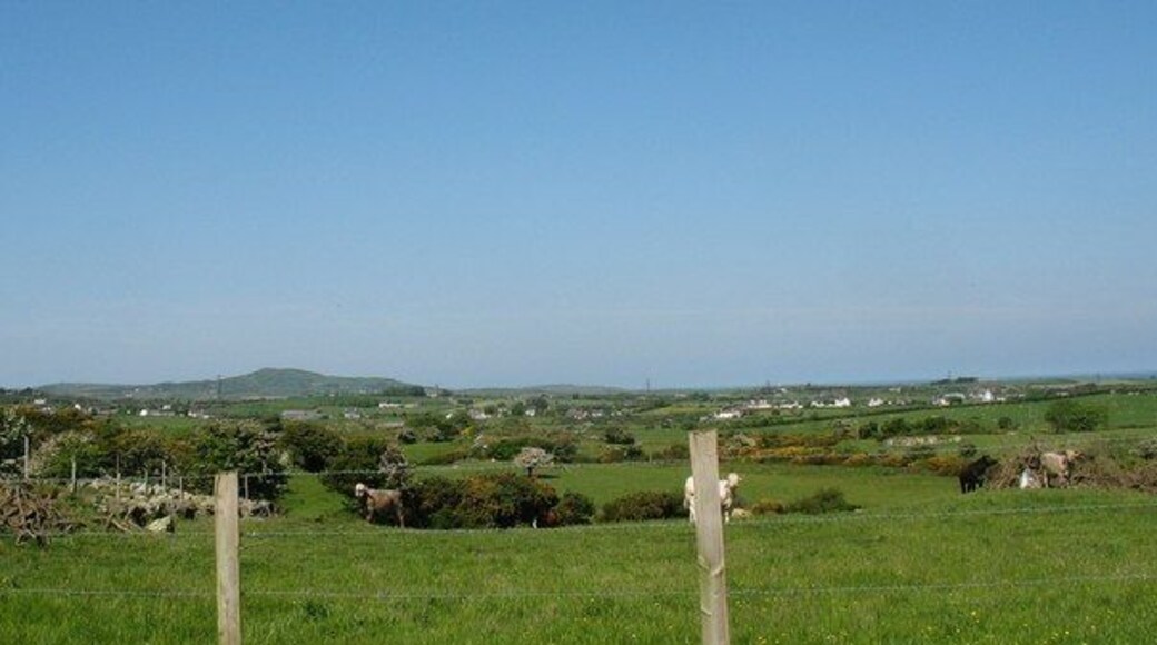 View westwards across grazing land in the direction of the Llanfechell-Mynydd Mechell road The mountain in the background is Mynydd y Garn SH3190.