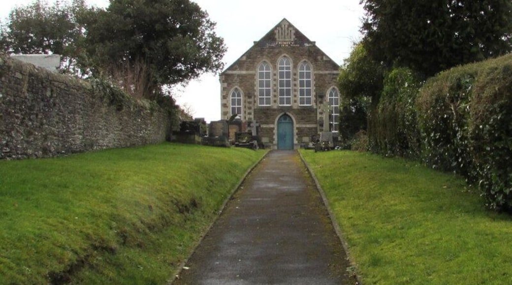 Trinity, Pontarddulais. The church is set back 55 metres from the A48 St Teilo Street. Trinity is the only English word on the Welsh language information board, which shows EGLWYS FETHODISTAIDD (Methodist Church).