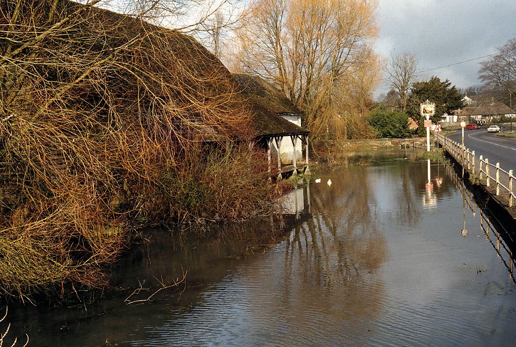 The River Ebble at Coombe Bissett Looking northeast on the main Blandford - Salisbury road, the old mill is to the left.