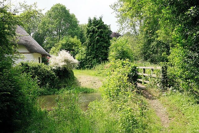 Footbridge & ford across River Ebble, Stockbridge Cottage, Coombe Bissett. The footpath which runs south from Homington House, crosses the River Ebble here and enters the built-up northern edge of Coombe Bissett. The thatched cottage on the far bank is called Stockbridge Cottage.