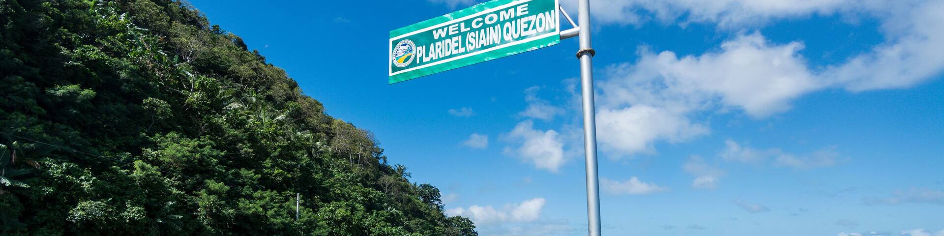 A signboard along a Philippine highway in Plaridel, Quezon. With scenic views of coastline.