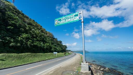 A signboard along a Philippine highway in Plaridel, Quezon. With scenic views of coastline.