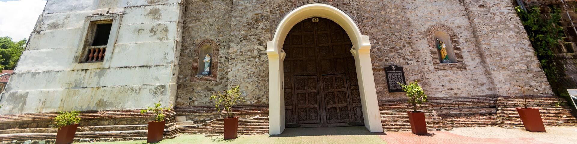 A historic church with a bell tower and a large arched entrance.