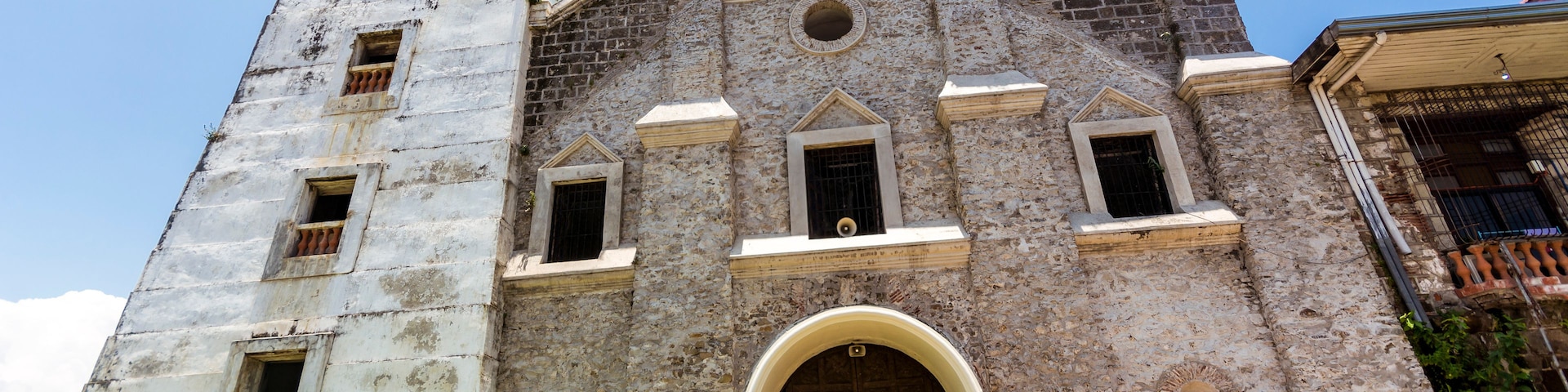A historic church with a bell tower and a large arched entrance.