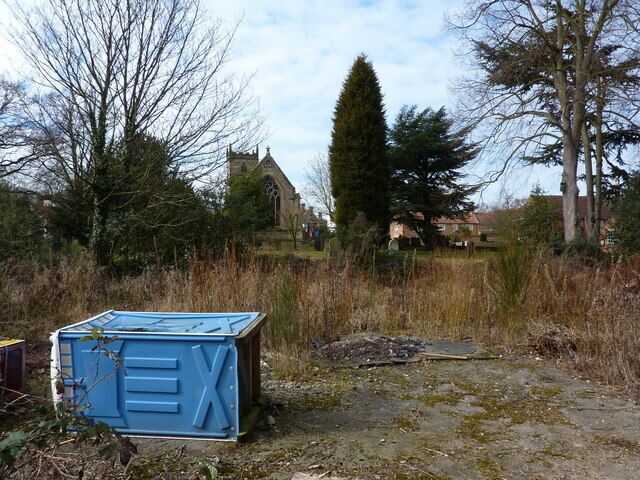 Village church and some rubbish The site of the former Co-op shop, I'm told, in the village of Woodborough.