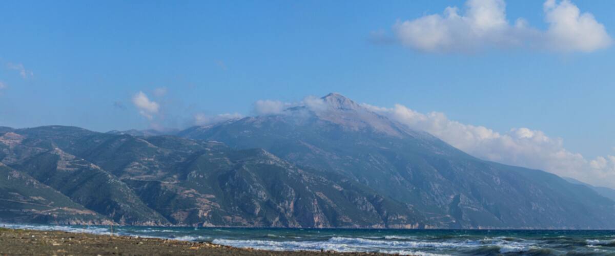 A coastal mountain range with a clear sky.