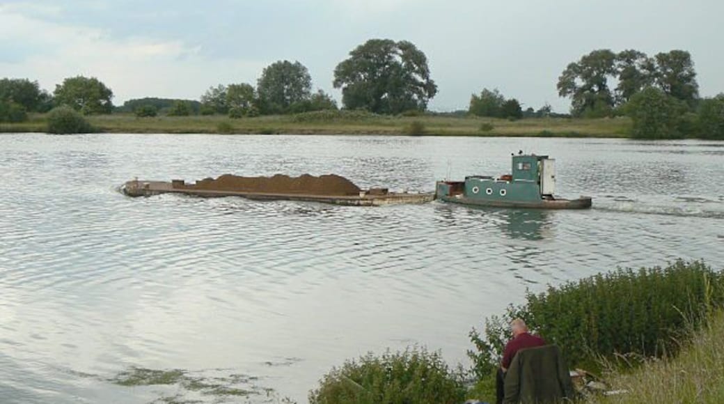 Work and leisure A contrast in water uses, with the fisherman in the foreground and the gravel barge beyond.