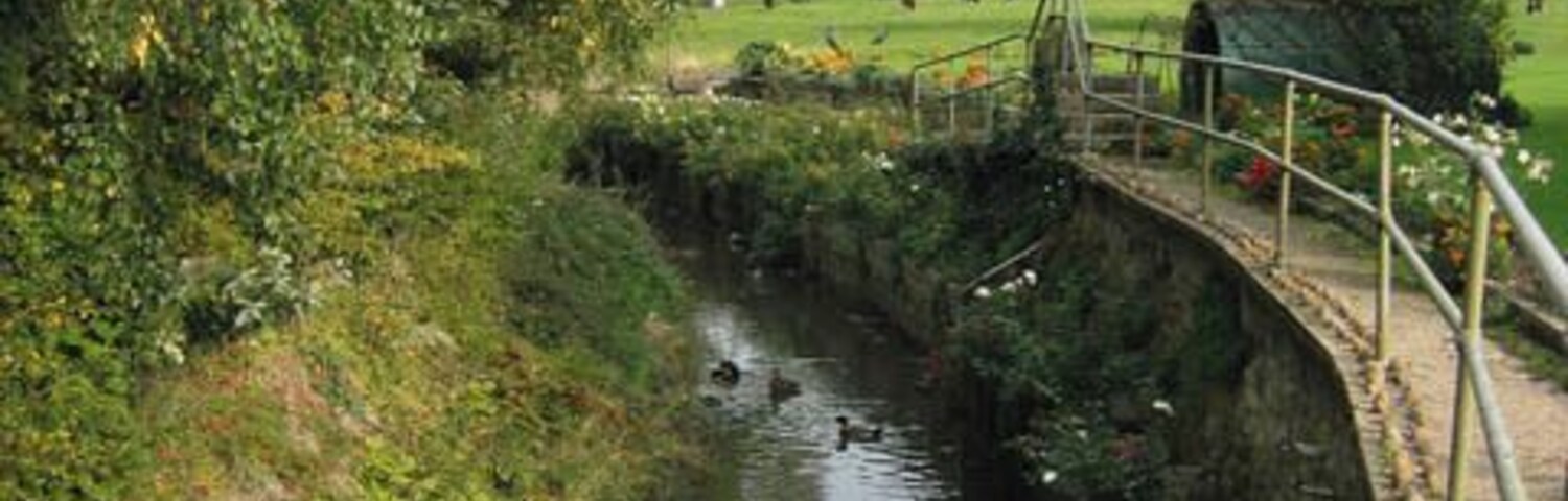 River Devon at Bottesford. The river passes through the north side of the village and in front of the church (St Mary the Virgin) Taken from the footbridge over the ford in 614083.