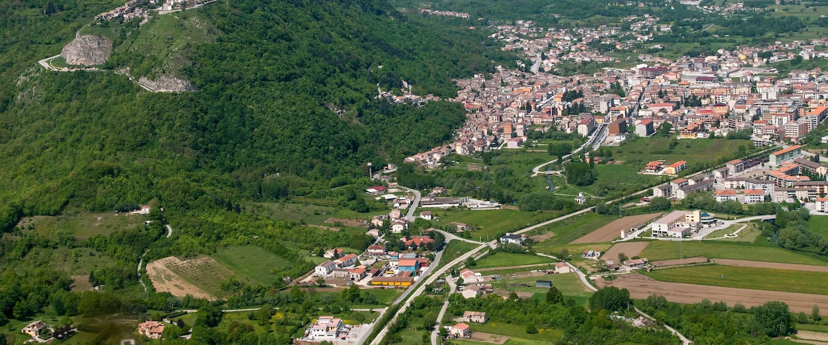 A town nestled in a valley surrounded by mountains.
