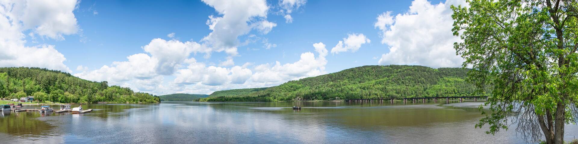 A panoramic view of a small marina at Mattawa, Ontario's waterfront where the Ottawa River meets the Mattawa River on a beautiful sunny day.