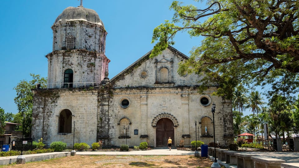 A historic church with a bell tower and arched windows.