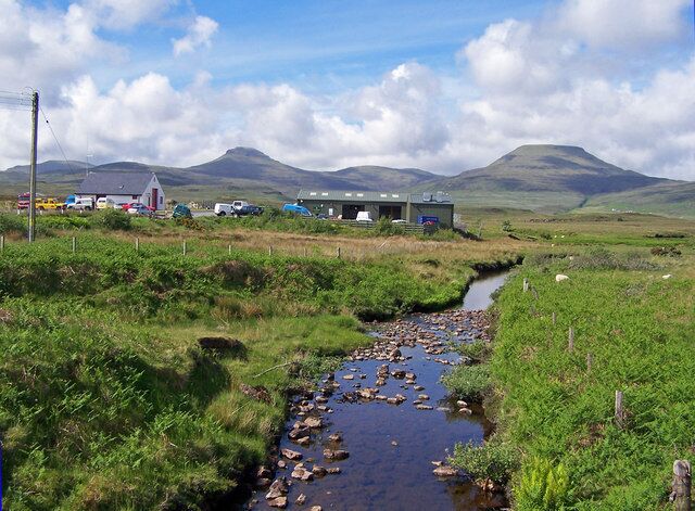 River Horneval, Lonmore The white building on the left is the Fire Station, and the green shed is a garage workshop - strangely set in a very rural location with MacLeod's Tables in the background.