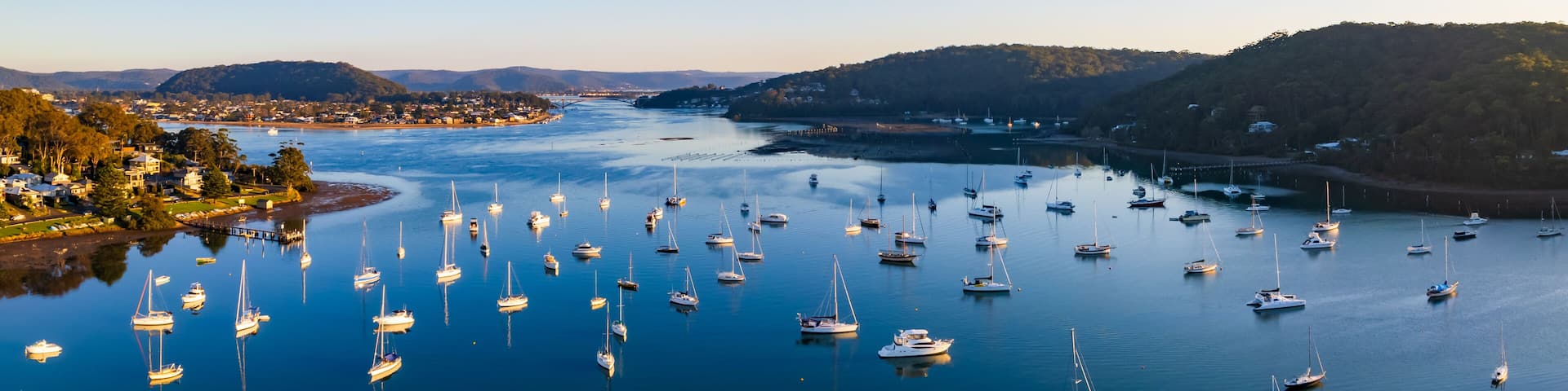 Early morning aerial waterscape panorama with boats
