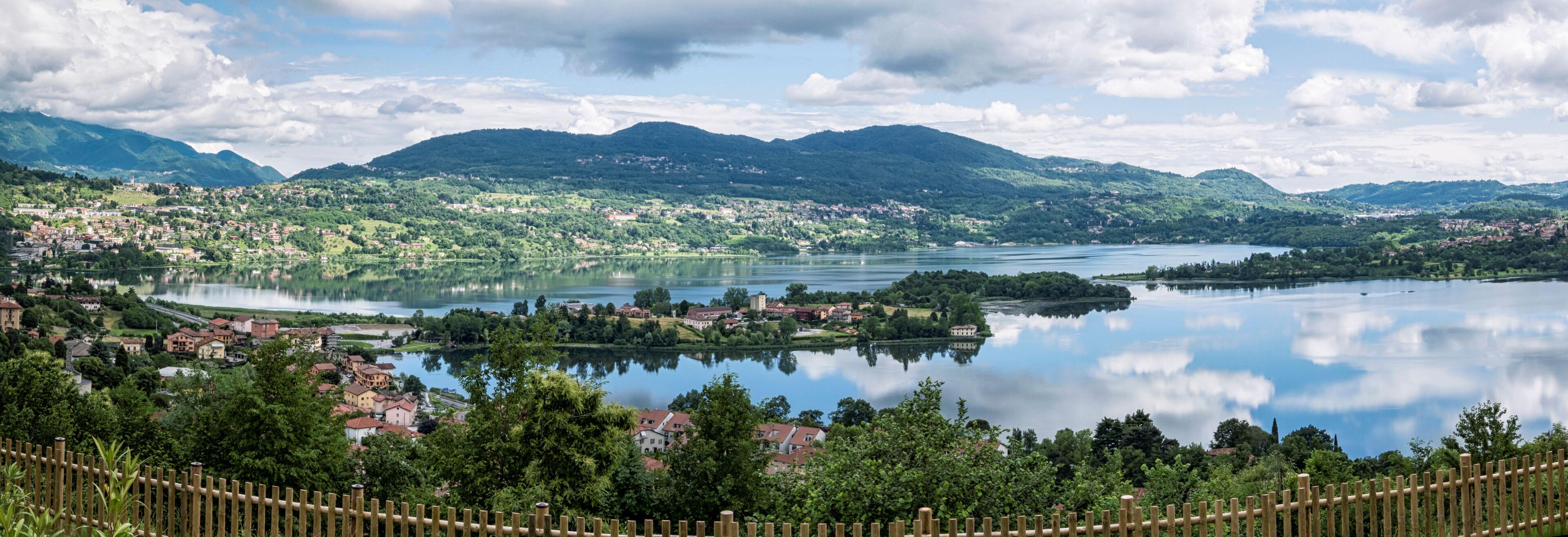 A lake surrounded by mountains and a town.