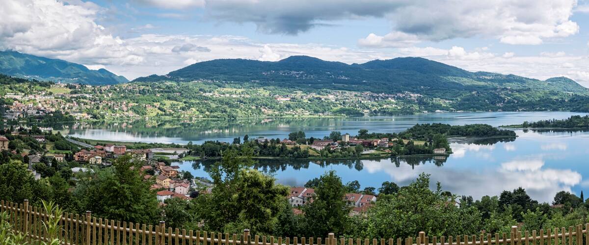 A lake surrounded by mountains and a town.