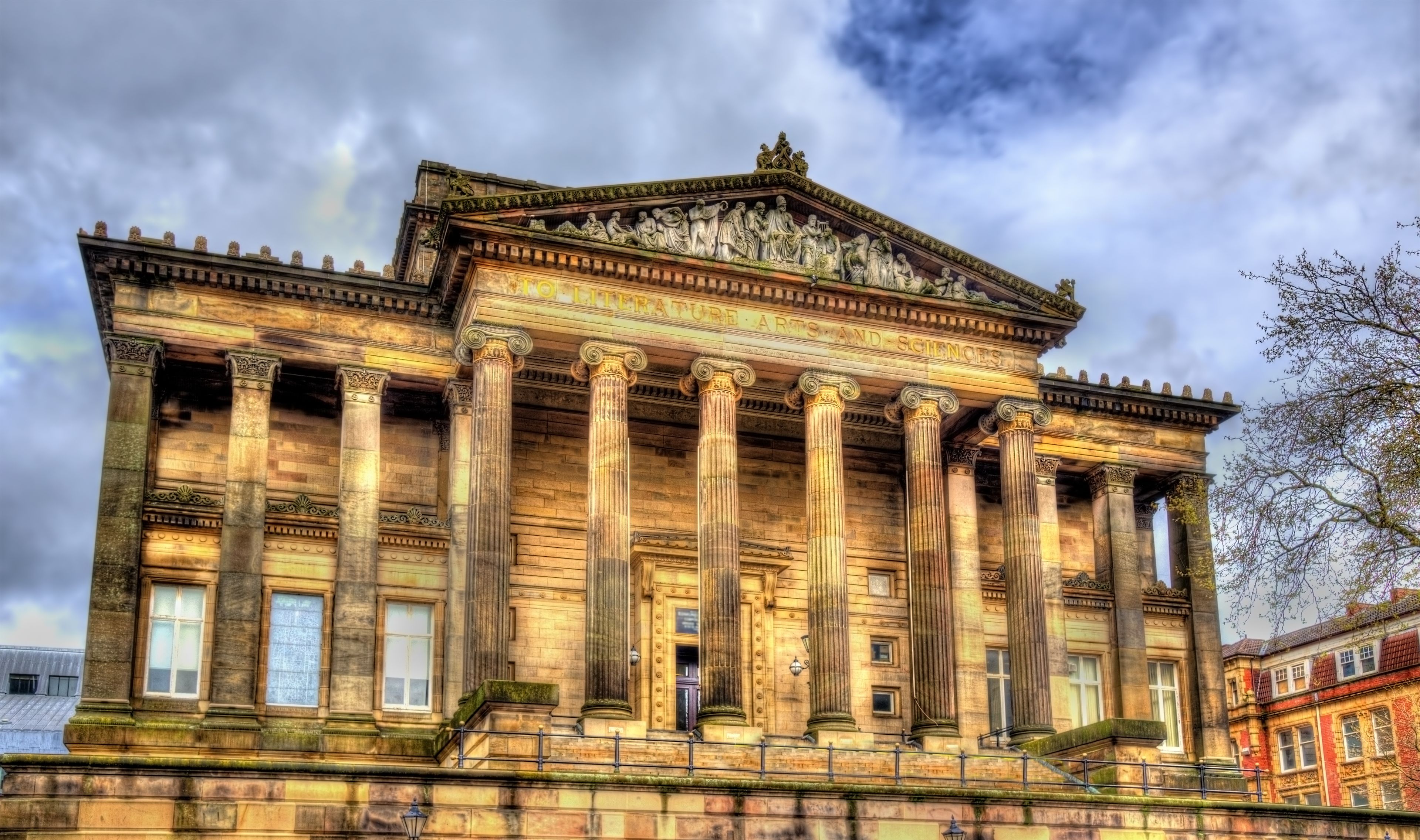 A classical building with columns and a detailed frieze.