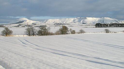 Snow covered arable land, Milnathort Farmland with a view towards West Lomond and Bishop Hill.