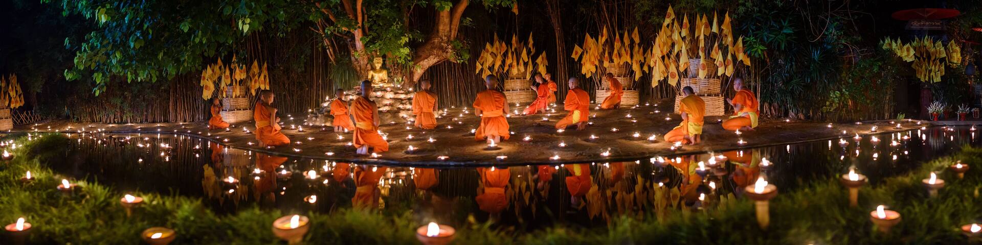 CHIANG MAI, THAILAND - May 18: Visakha Puja Day Thai monks sitting meditate with many candle at Phan Tao temple on May 18, 2019 in Chiang Mai, Thailand.