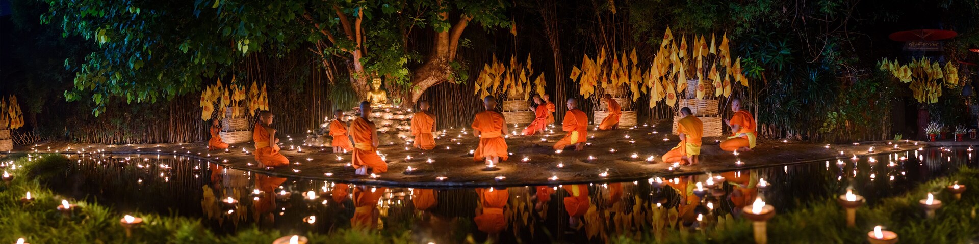 CHIANG MAI, THAILAND - May 18: Visakha Puja Day Thai monks sitting meditate with many candle at Phan Tao temple on May 18, 2019 in Chiang Mai, Thailand.