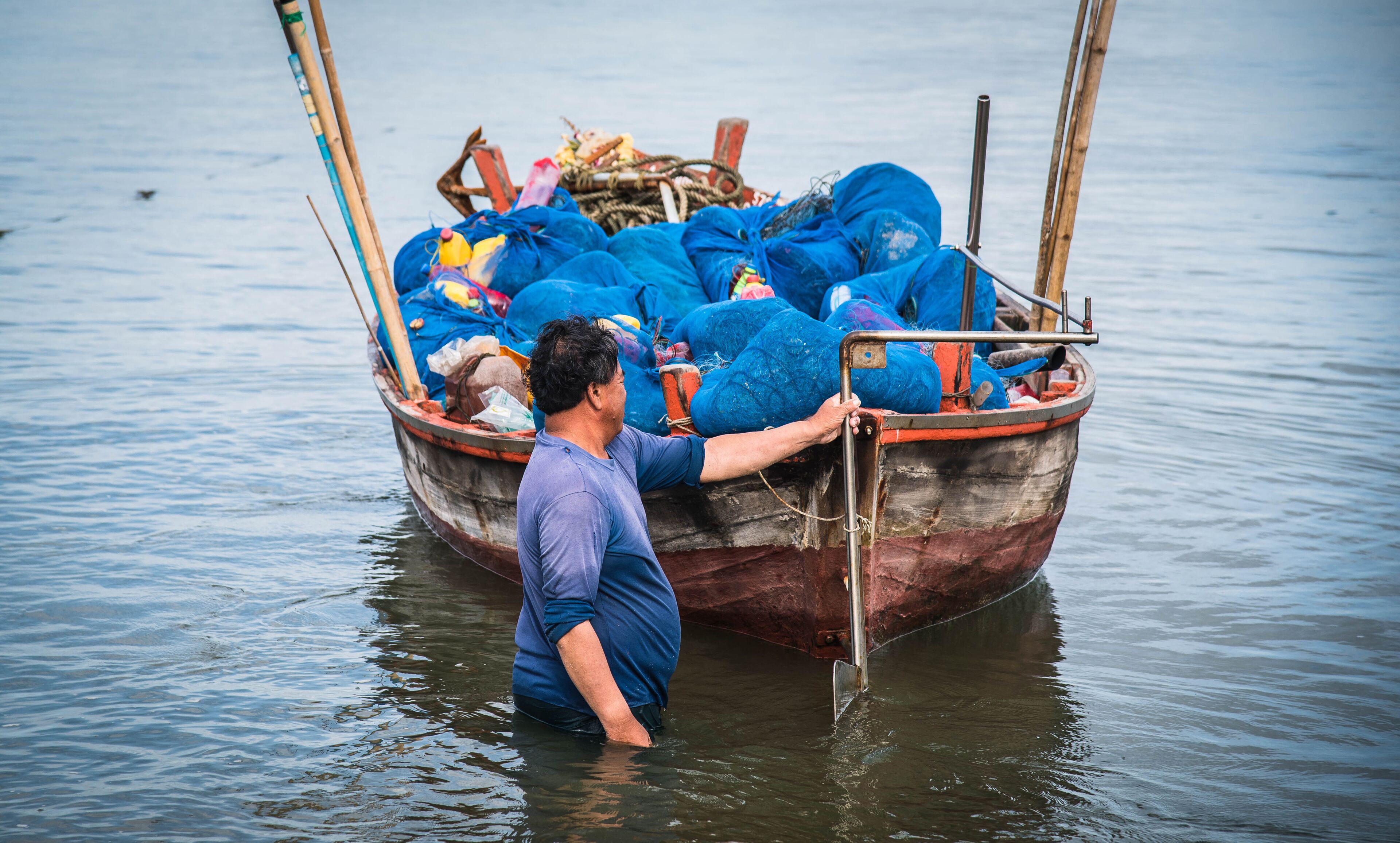 Local fishermen are about to take a boat out to sea to fish at Ban Bang Phra, Thailand