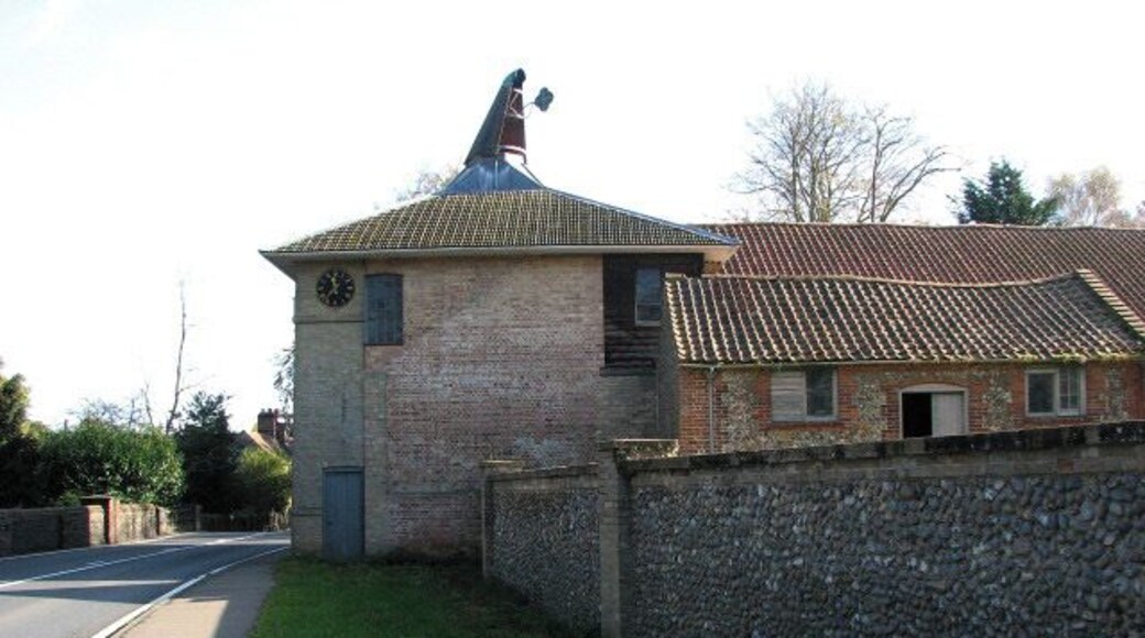 The maltings. The now disused brewery was built in 1783 by William Hardy from East Dereham, who conducted his business as a maltster from Coltishall, using his own wherry for the transport of goods. After moving to Letheringsett Hall > 1025717 with his family in 1781, he purchased the maltings and Hagan's brewery, situated across the road from the Hall, and there built the Letheringsett Brewery, originally constructed to function as a malt mill. The maltings are built from gault brick with some flint and have a hipped roof. Later a new mill was built within the existing main building and the first wheat ground here was sold in December 1784. Part of the complex is presently used for general storage.