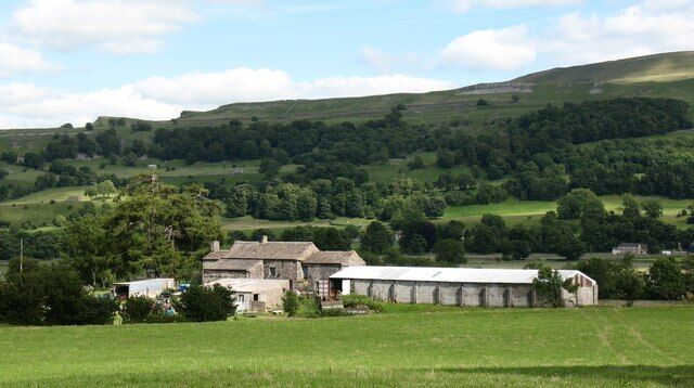 Spickles Farm Old farmhouse with a modern barn at the lower end of Bishopdale.