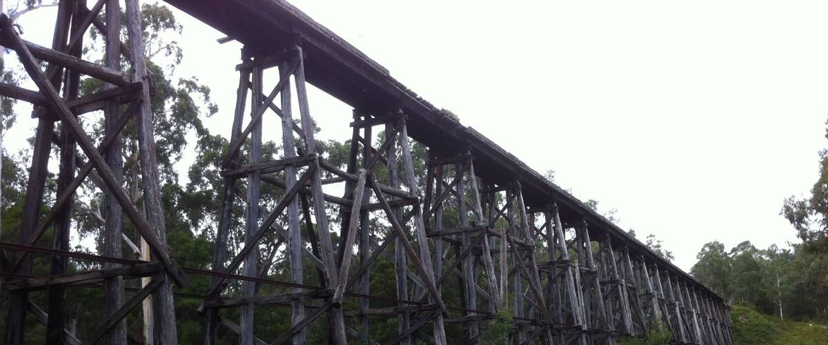 A large, old wooden bridge with metal railings.