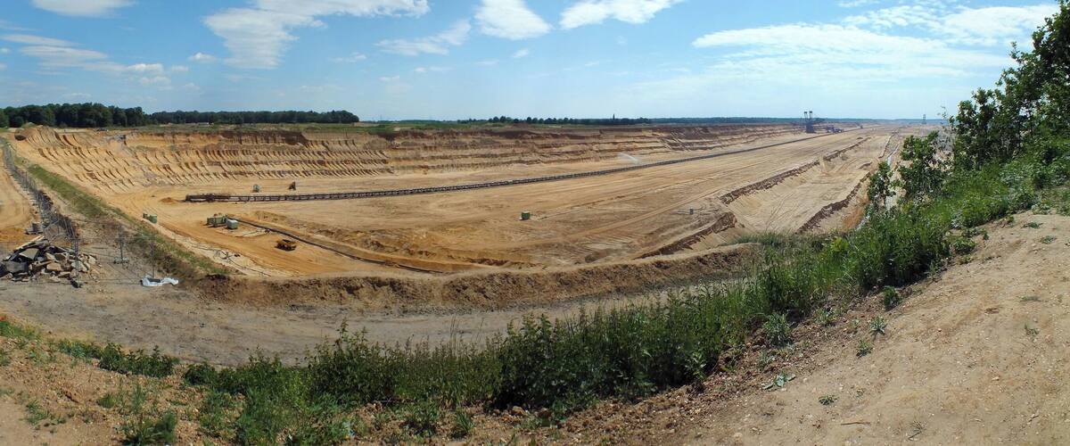 A large construction site with multiple excavators and heavy machinery.