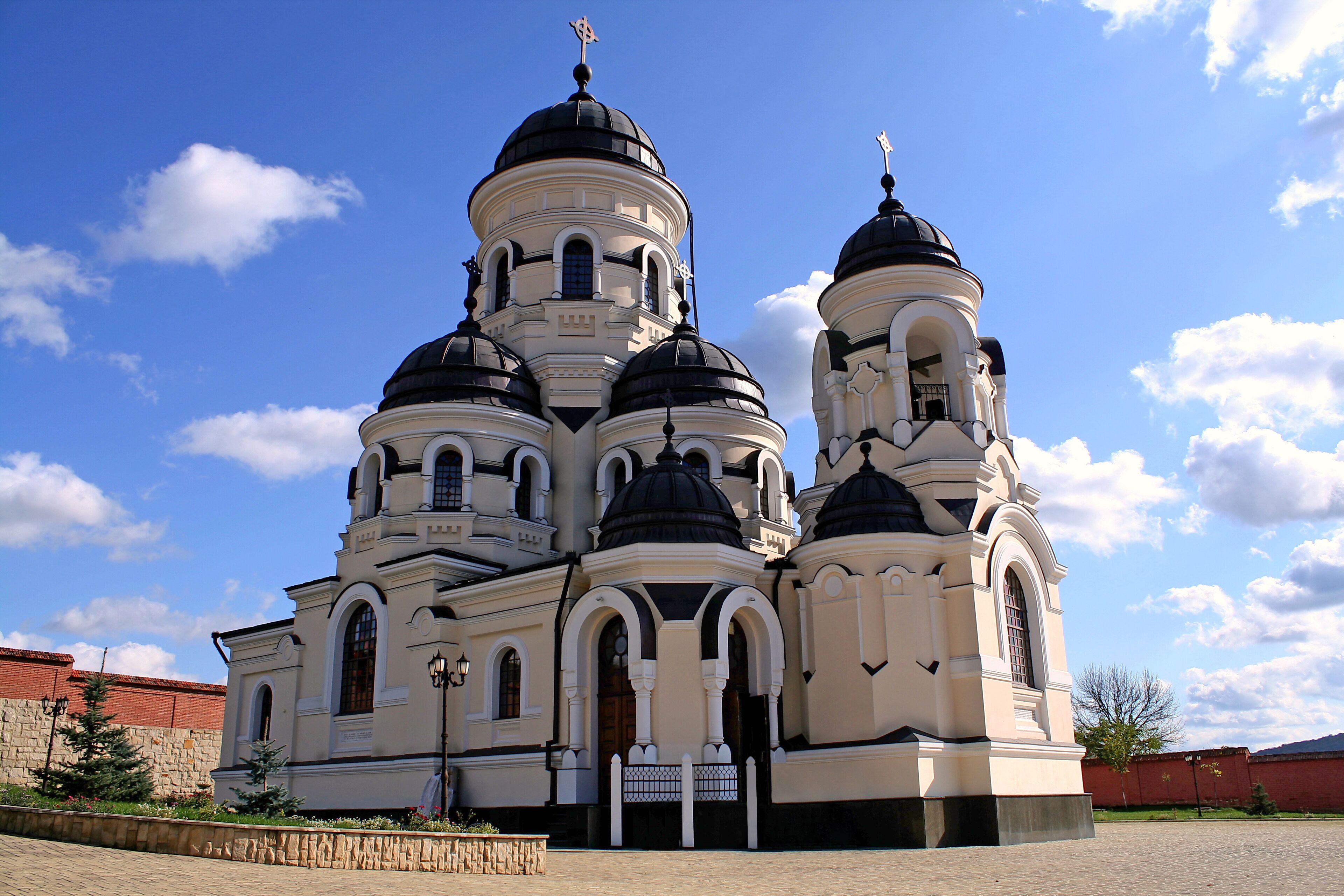 A church with multiple domes and a cross on top.