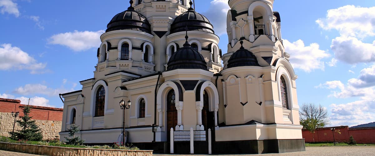 A church with multiple domes and a cross on top.