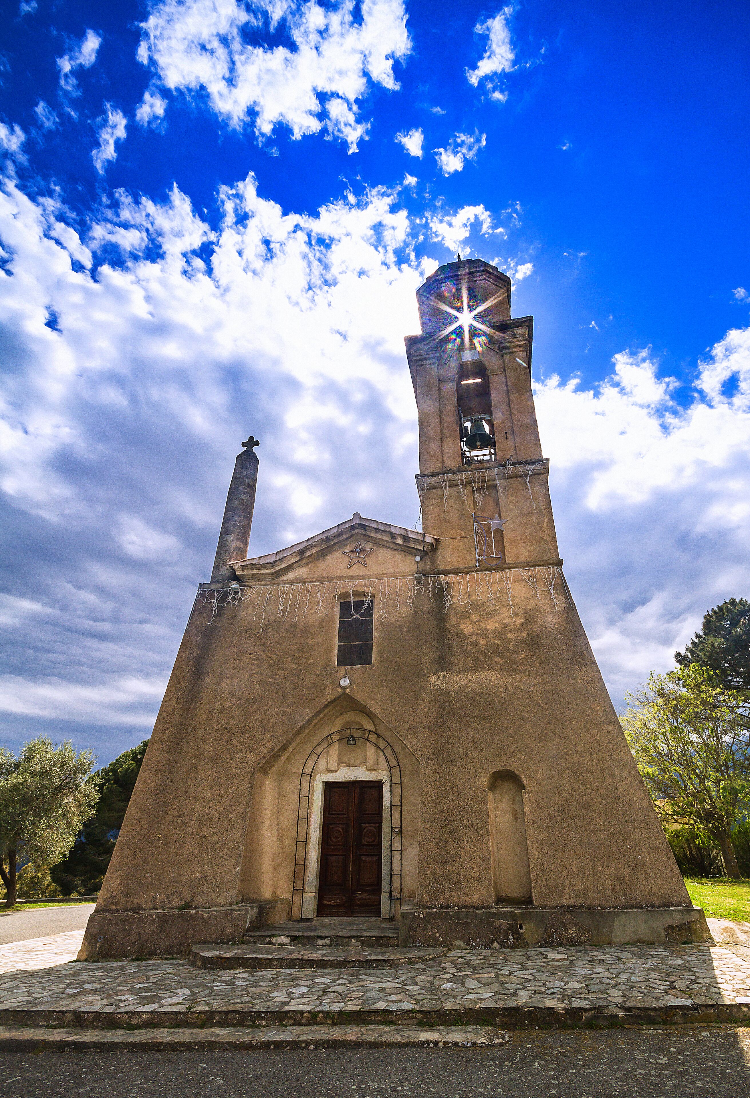 A church with a bell tower and a star on the facade.