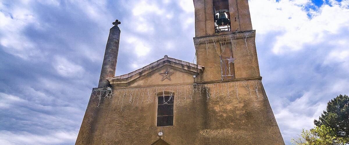 A church with a bell tower and a star on the facade.
