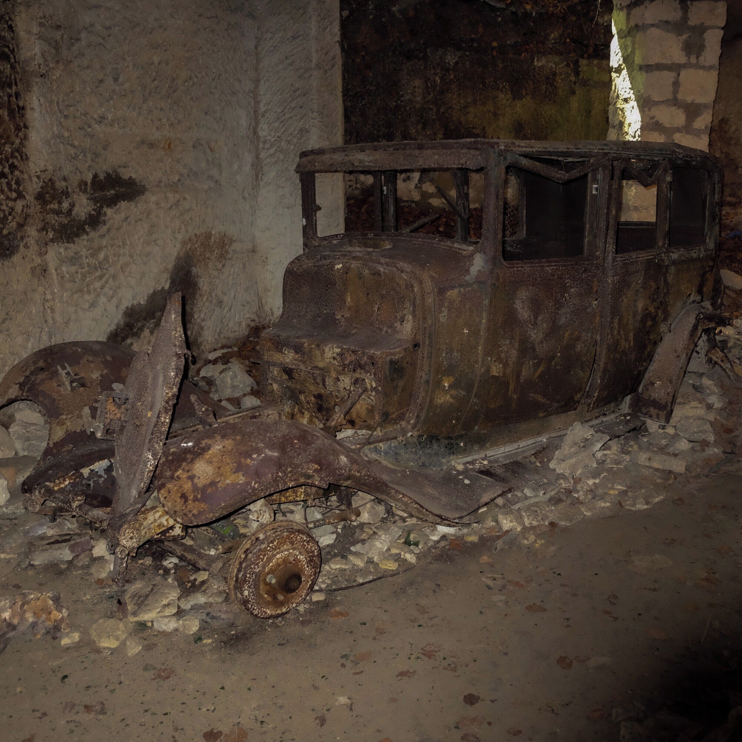 Haunting Burnt Out Car in "War Caves". 

Story goes: "This cave network was captured by the Germans during the war. As a warning to the villagers not to resist the Germans, two members of the French resistance were tied into this car. They were pushed in through the cave entrance by the German aggressors, then the car was burnt with the members of the resistance inside it"