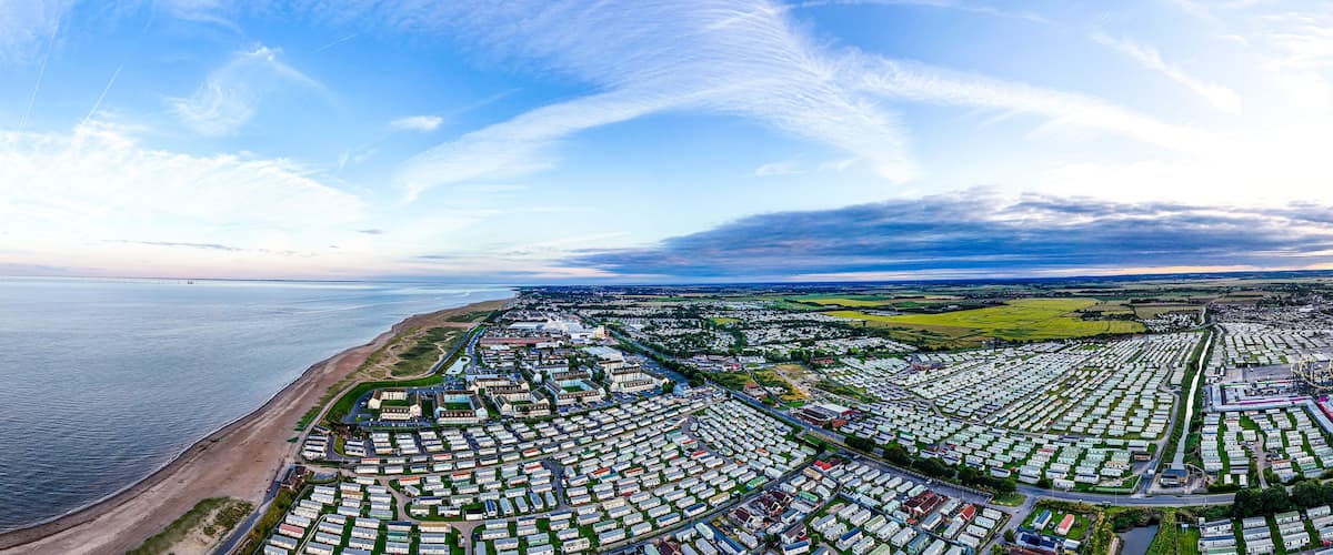 Sunset Aerial Panoramic View of the UK Seaside Ingoldmells, a busy tourist town with something for everyone, from stunning campsites to a sunset to die for, showcases the beauty of a serene sunset