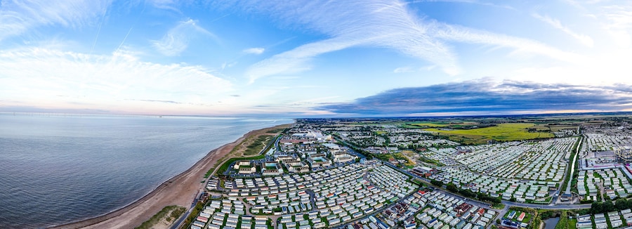 Sunset Aerial Panoramic View of the UK Seaside Ingoldmells, a busy tourist town with something for everyone, from stunning campsites to a sunset to die for, showcases the beauty of a serene sunset