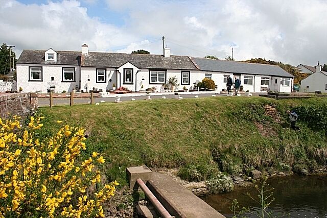 Cottages at Powfoot A row of more or less traditional cottages beside the Pow Water. The concrete structure in the foreground presumably carries services across the burn.