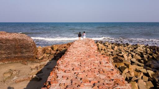 The ruins of ancient brick walls of Fort Dansborg leading to the sea in the ancient Danish colony of Tranquebar.