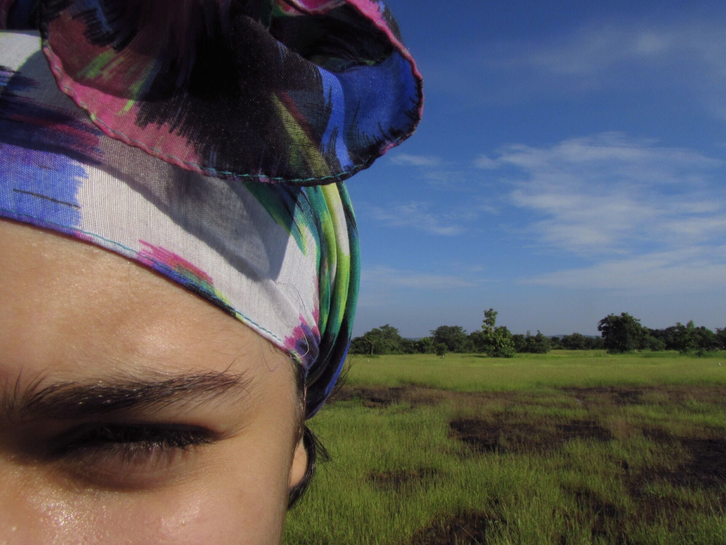 Behind the plantation land owned by Maachli, there begins an upward forest trail that leads from a canopy of trees to this open landscape of blue vs green.
A shot of my 12 year old sister, Ryanna, eyes squinted by the Sun.