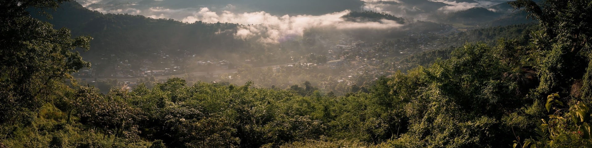 Aerial view of a beautiful sunny sky over rural valleys and cliffs in Nongpoh, India