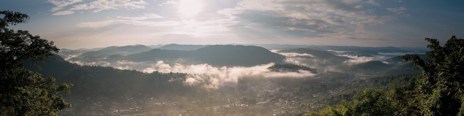 Aerial view of a beautiful sunny sky over rural valleys and cliffs in Nongpoh, India