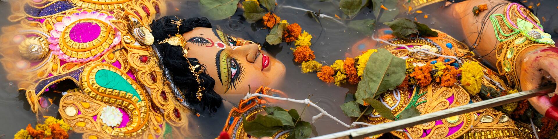 Hindu devotees immerse a clay idol of Goddess Durga into the Brahmaputra River on the concluding day of the Durga Puja festival
