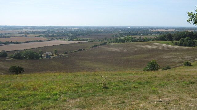 View from the North Downs Way The long distance path heads downhill towards Boughton Aluph. Wye is seen on the left in the background. Soakham Farm is in the foreground.