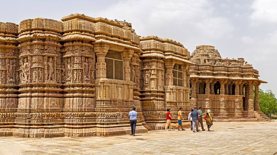 A large, intricately carved temple with multiple tiers and detailed sculptures.