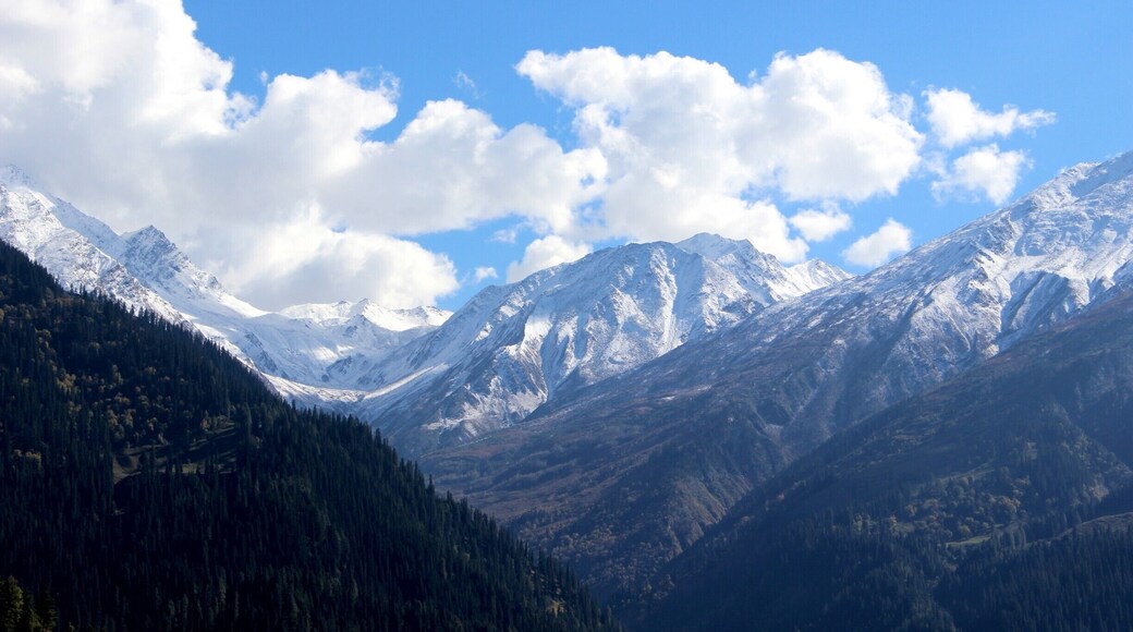 View of enchanting #snow capped mountains on a trek through the serene village 'Tosh' of Himachal Pardesh.