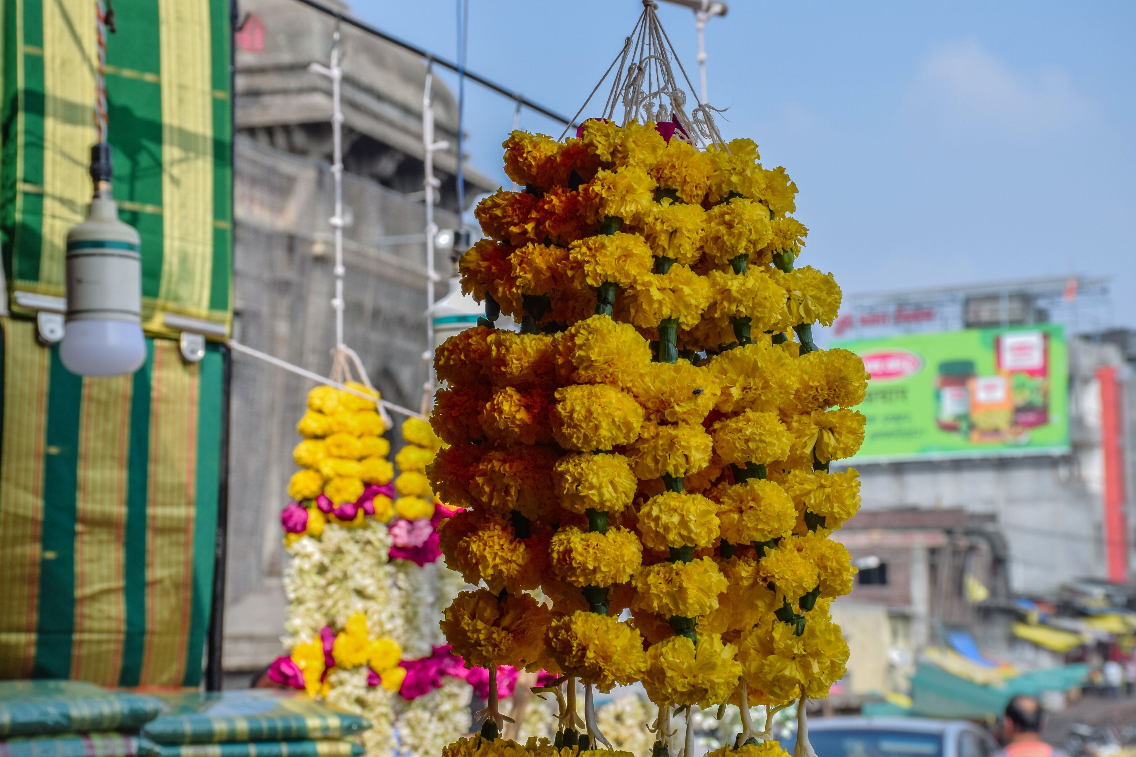 A street market with a large display of yellow marigold flowers.