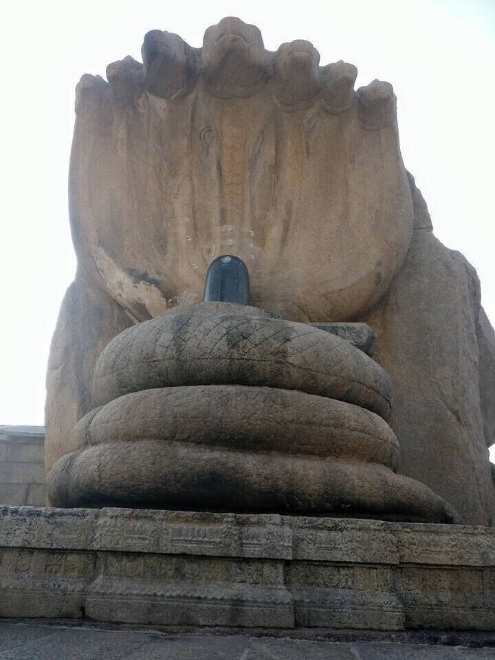 Shivalinga with serpent carved on a single rock, which extends to some area at the back