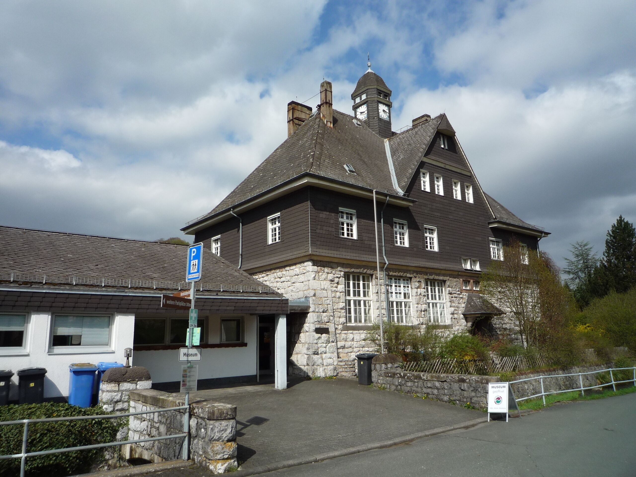 A historic building with stone walls and a clock tower.