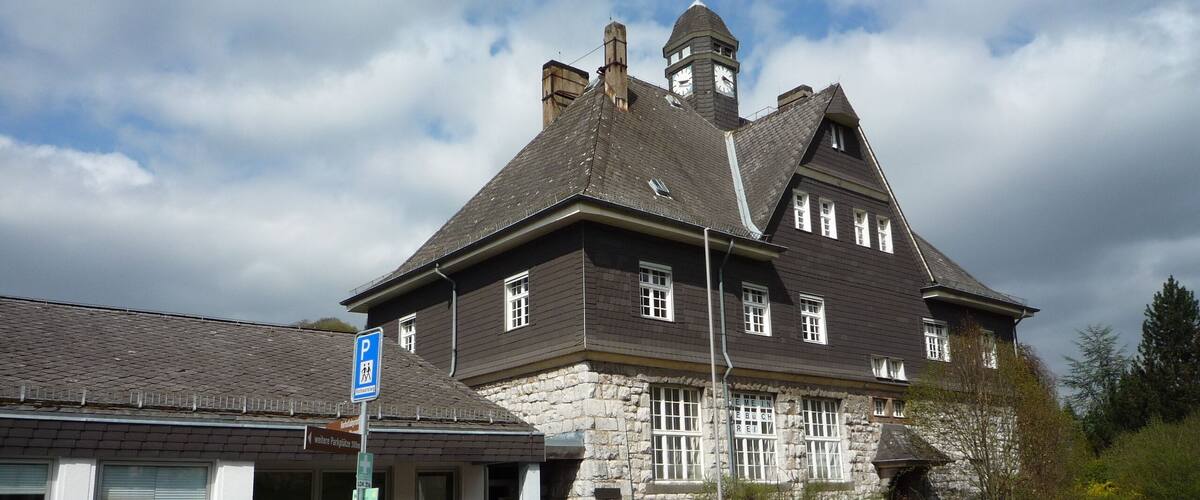 A historic building with stone walls and a clock tower.
