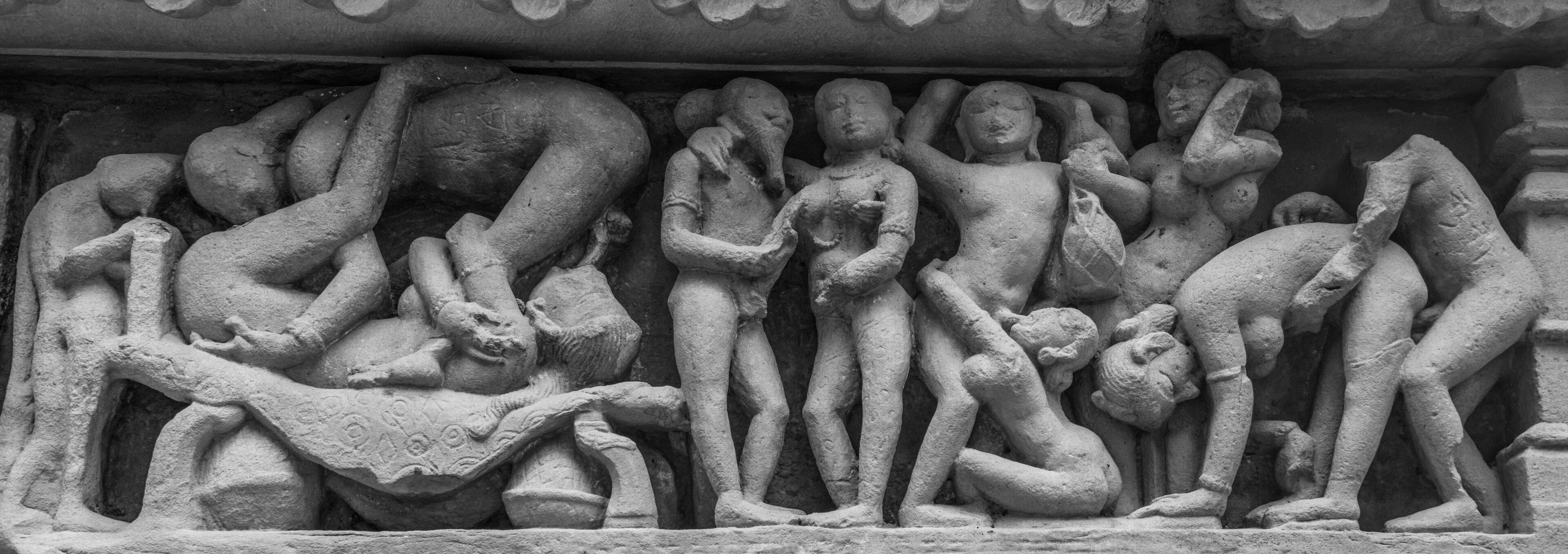 A stone sculpture of multiple figures in various poses, likely depicting a mythological or historical scene.