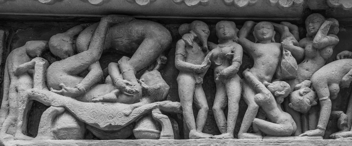 A stone sculpture of multiple figures in various poses, likely depicting a mythological or historical scene.